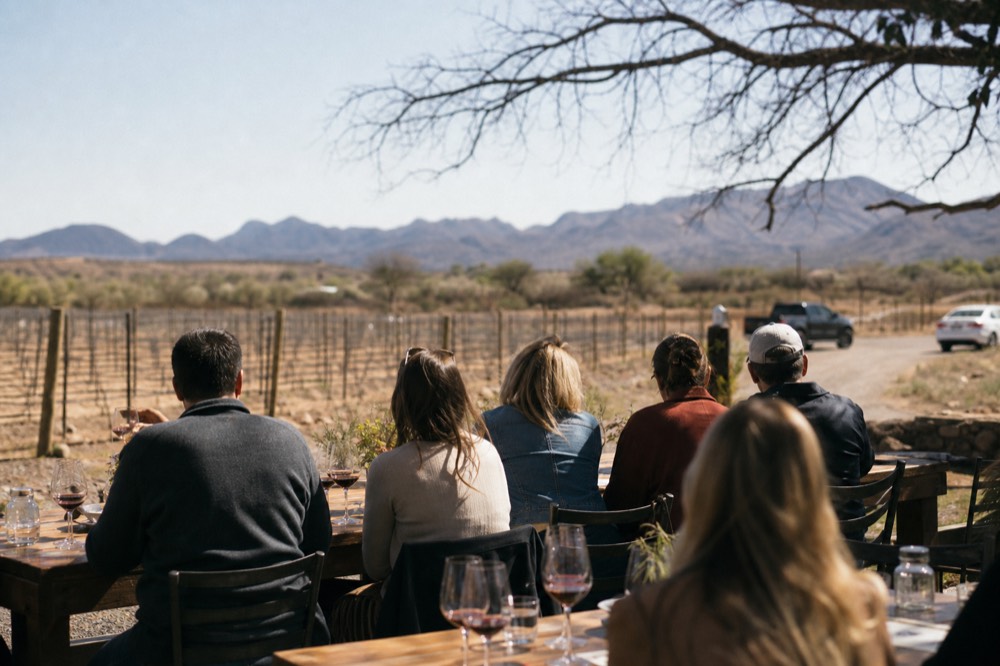Small group tasting wine among vineyard rows in the Verde Valley near Sedona